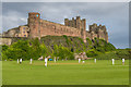 NU1835 : Cricket below the castle by Ian Capper