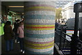 View of a mosaic column next to Notting Hill Gate station