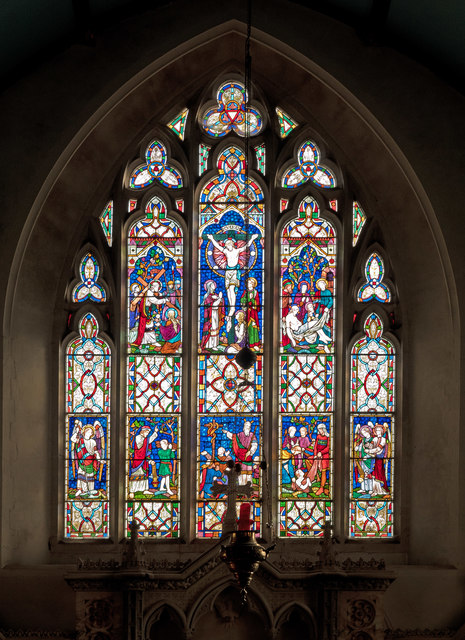 A stained glass window above the altar in the church of St Michael & All Angels, Torrington