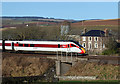 An LNER train passing Fairnieside Farm