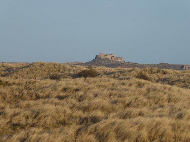 Lindisfarne Castle appears over the dunes