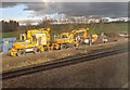 Construction vehicles next to the railway line at Hare Park Junction, seen from the train