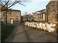 Sandbags against the railing alongside Clifton Beck, Brighouse