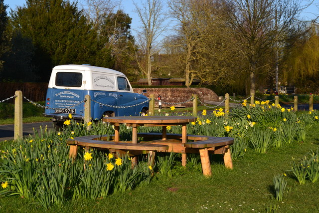 Picnic table and daffodils on the green at East Lavant