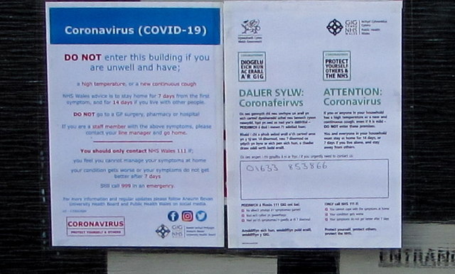 Coronavirus (COVID-19) notices on the entrance door to Malpas Dental Surgery, Newport 
