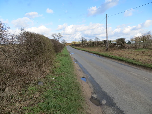 Hedge-lined Eccles Road near to Harling Farm