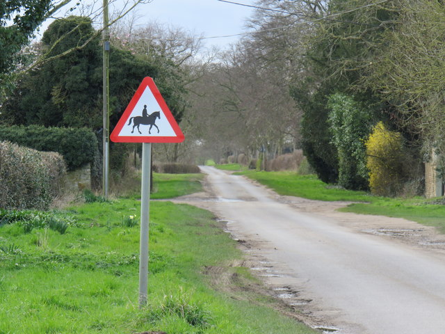 An accompanied horse warning sign on a remote country lane