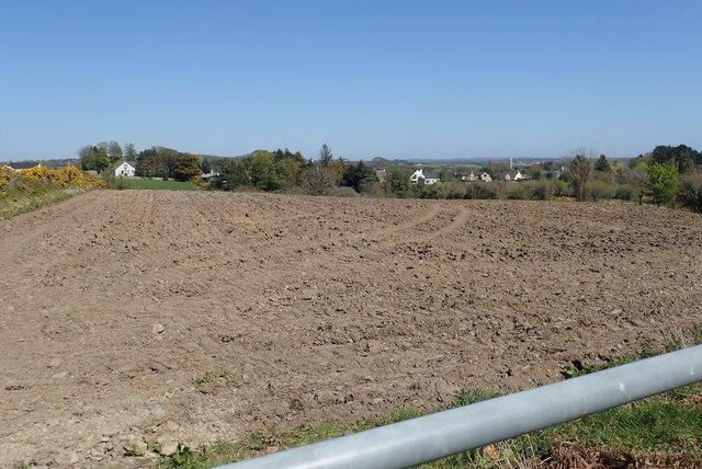 View North-eastwards across ploughed land to houses on the A50 (Castlewellan Road)