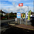 Red & white Leominster railway station name sign