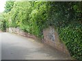 A defaced and repaired wall, Belle Isle, Exeter