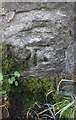 Benchmark on stone in wall on west side of Whashton Road