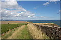 NO7047 : Clifftop farm track near Red Head by Andrew Diack