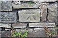 Benchmark on stone in wall on west side of Bradford Road
