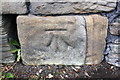 Benchmark on wall on east side Sheffield Road