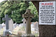 SO5923 : Sign in churchyard by John Winder