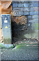 Benchmark at junction of walls at Holyhead Road railway bridge