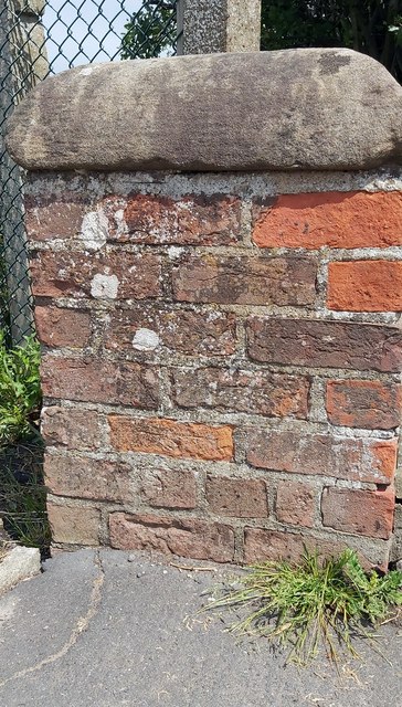 Damaged Benchmark on the wall of Clapham Lodge