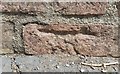 Close Look at the damaged benchmark on the wall of Clapham Lodge