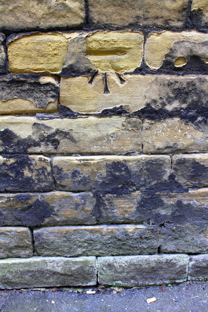 Benchmark on wall on SE side of Longside Lane