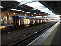 A single car class 153 unit stands in Grimsby Town station