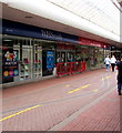 Red barriers across an entrance to WH Smith, Cwmbran