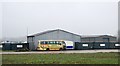 Warehouses on edge of disused airfield