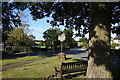 Seat and village sign opposite Little Yeldham church