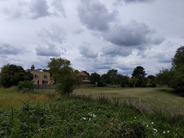 Grass field and houses viewed from Darent Valley Path