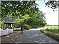 Cyclist pausing by the lych gate at Great Totham