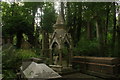 View of a monument shaped like a church tower in Highgate West Cemetery