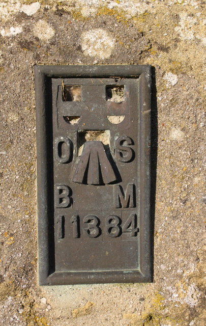Benchmark on barn at junction of B6480 and Cross Haw Lane