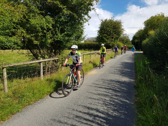 Cyclists pass Elmbridge Manor, Worcestershire