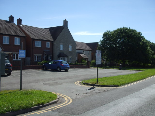 A small car park in front of the houses