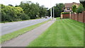 TL1596 : Grass strip beside pavement on south side A605 by Roger Templeman