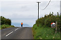 A cyclist heads over the hill on Cranagh Road