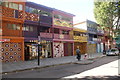 TQ3881 : View of shops decorated for the London Mural Festival on Aberfeldy Street #2 by Robert Lamb