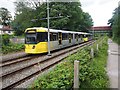 Metrolink tram leaving East Didsbury tram stop