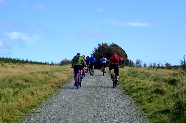 Mountain Bikers ascending towards the col between The Drinns and Curraghard