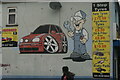 View of a car and mechanic mural on the side of 1 Stop Tyres on High Road Leyton