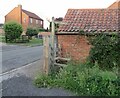 Stile by pavement on footpath