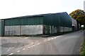 Large barn of Yew Tree Farm at road junction