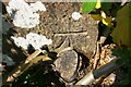 Benchmark on parapet of railway bridge on north side of B5302