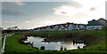 A balancing pond in front of bungalows on Penhill View