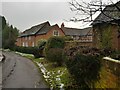 Timber framed house behind wall in Shenstone