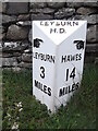 Modern milepost by the A684, opposite Alma Farm