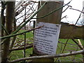 Passive-aggressive note in the hedge