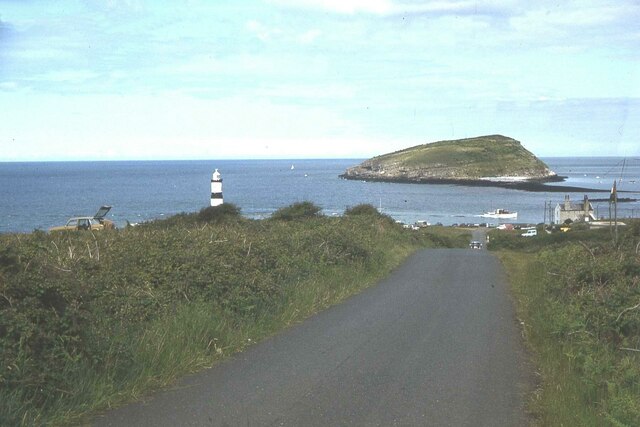Road leading down to Penmon Point with Priestholm beyond