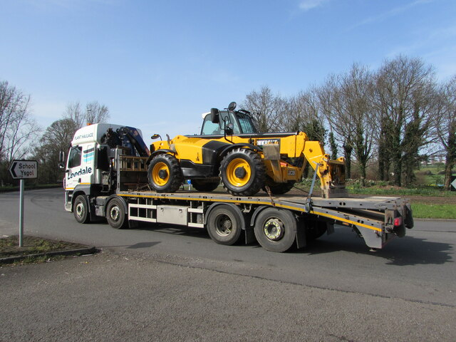 Yellow JCB in transit on the A40, Dixton, Monmouth