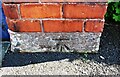 Benchmark on gatepost  base at entrance to Council depot yard, Boustead