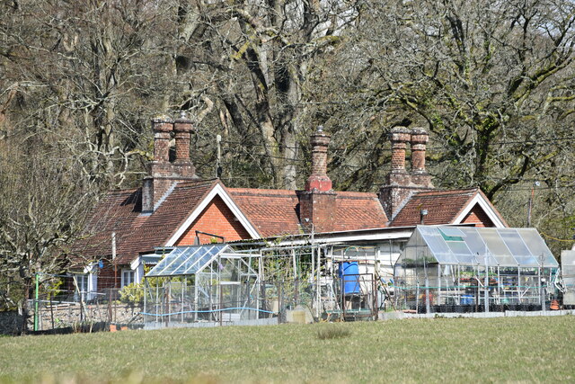 Cottage with glasshouses and ornate chimney stacks